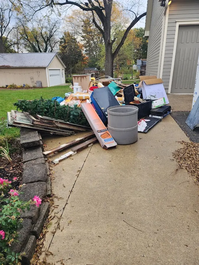 Dumpster being loaded with debris for Roofing Dumpster Rental in White Oak